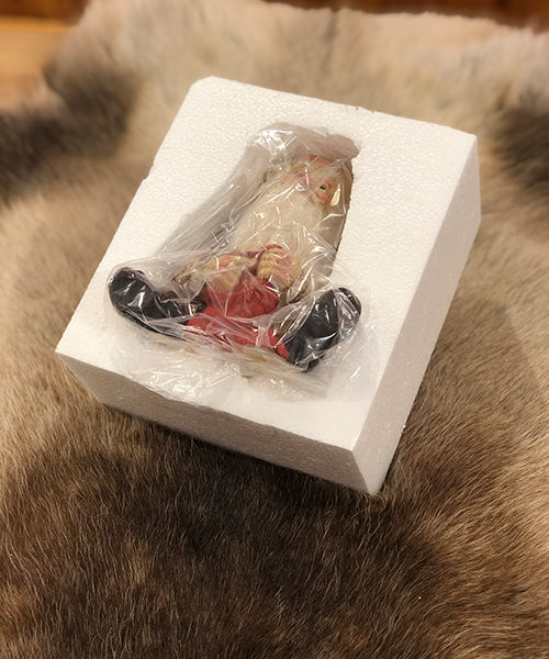 Midthun-nisse sittende med lue