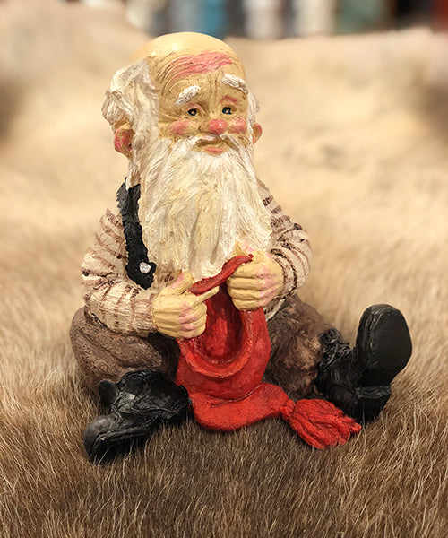 Midthun-nisse sittende med lue